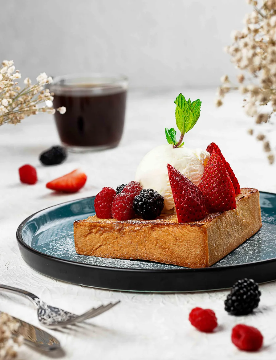 Plated dessert with fresh berries and ice cream — hospitality food photography