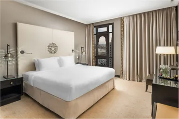 Elegant hotel bedroom with a view over Madinah