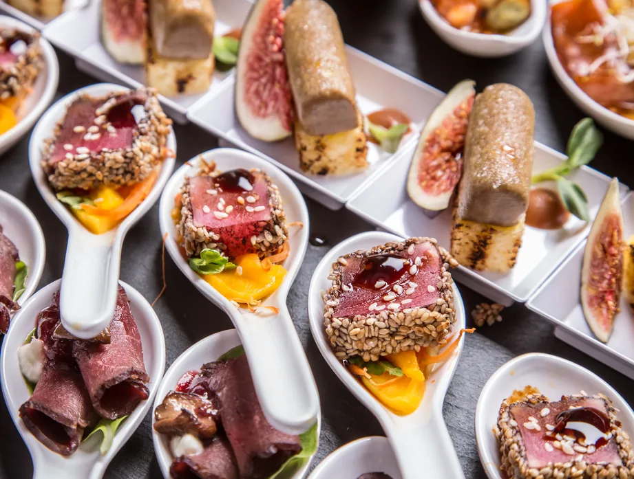 Canapés and appetizer spoons styled for a hotel buffet