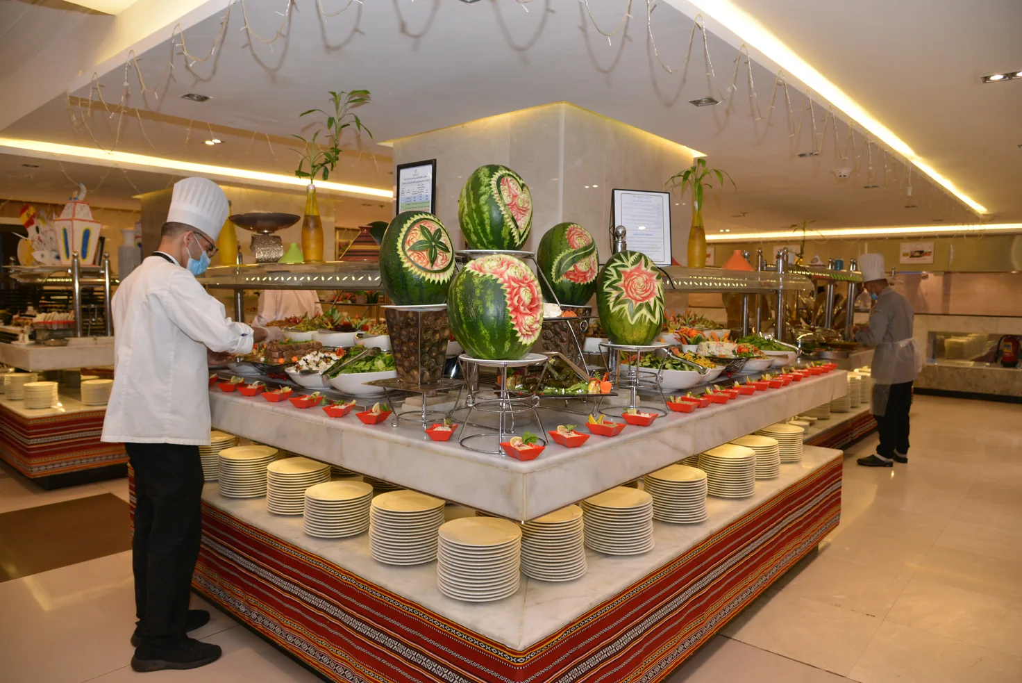 Lavish hotel buffet spread with carved-watermelon centerpieces