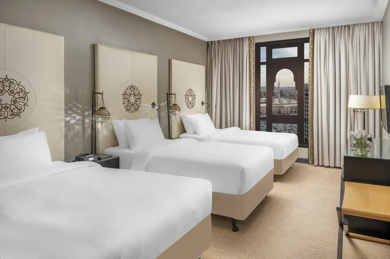 Guest room with three beds overlooking the Prophet's Mosque