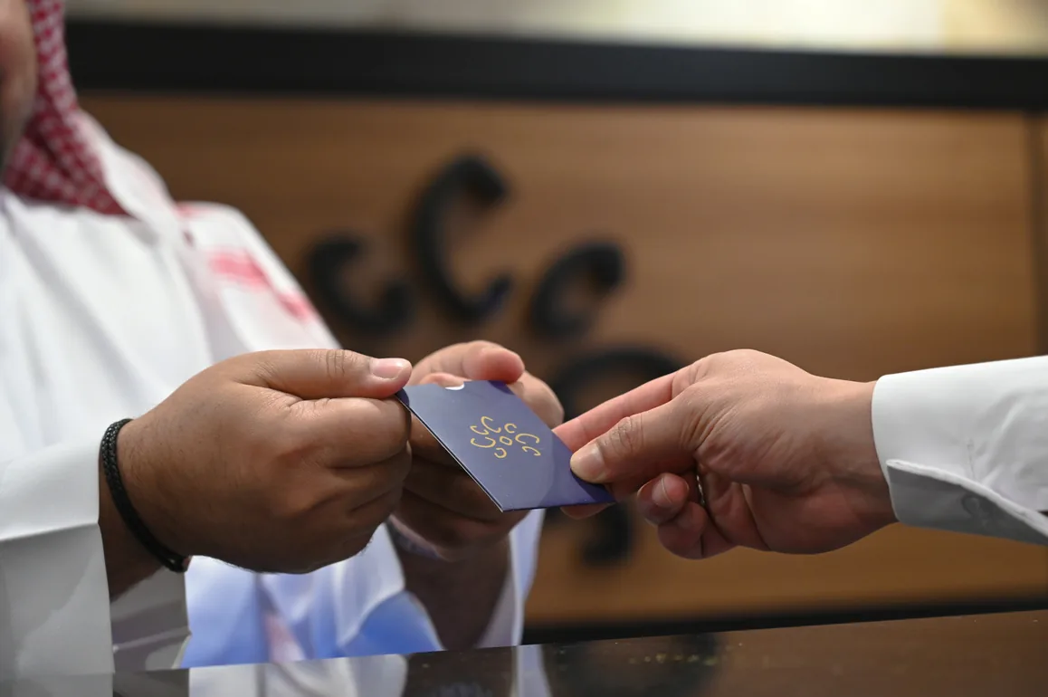 Receptionist handing a welcome card to a hotel guest