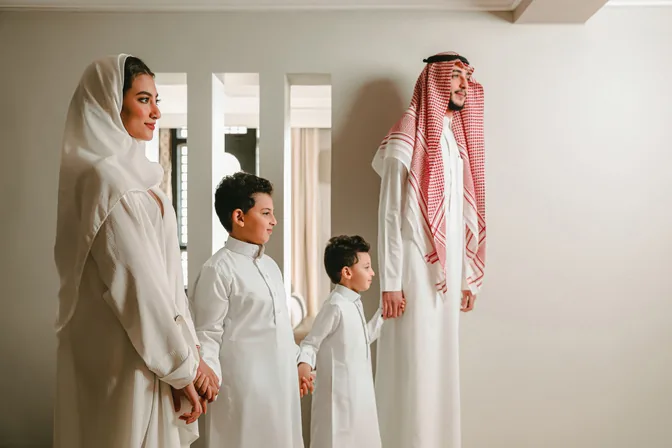 Saudi family hand in hand inside their hotel suite