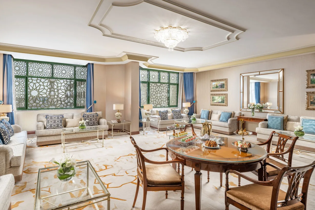 Palatial hotel suite lounge beneath a crystal chandelier